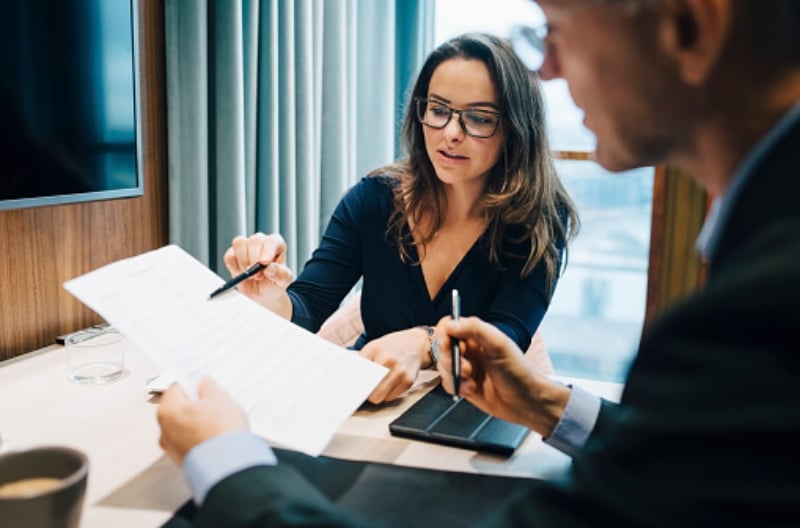 Two people collaborating and looking at information